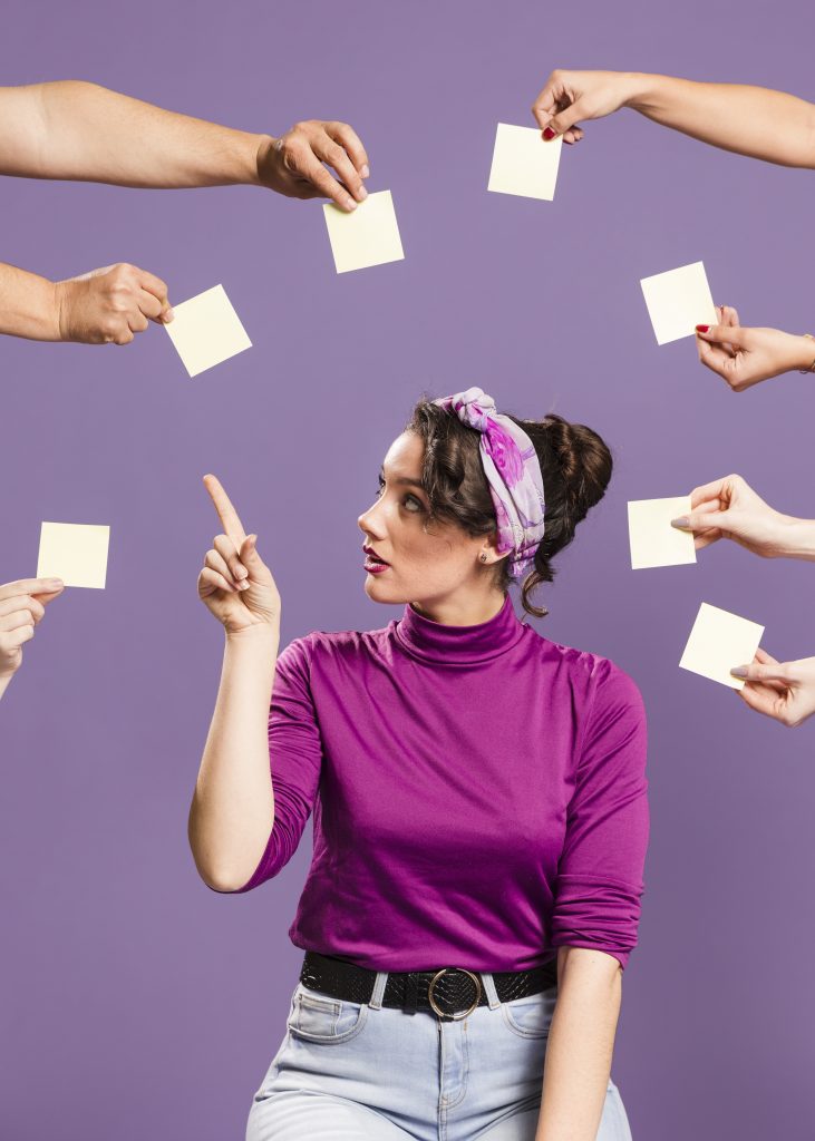 woman surrounded by hands sticky notes picking empty note